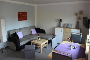 a living room with a couch and a table at Ferienhaus Sonneck in Klockenhagen