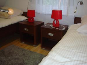 ウストカにあるDomki Zaciszeのベッドルーム1室(ベッド2台、ナイトスタンドのランプ2つ付)