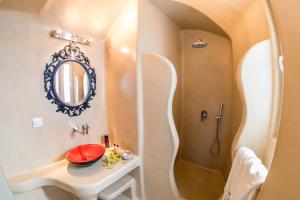 a bathroom with a sink and a shower at La Bellezza Eco Boutique Hotel in Kamari