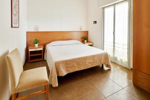 Postel nebo postele na pokoji v ubytování G/Hotel Lignano