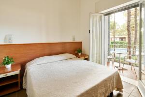 Postel nebo postele na pokoji v ubytování G/Hotel Lignano