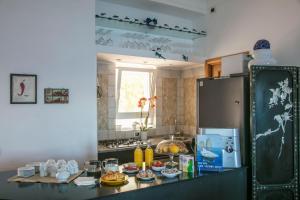 a kitchen with a counter top with a refrigerator at B&B Punta Vivara in Capri