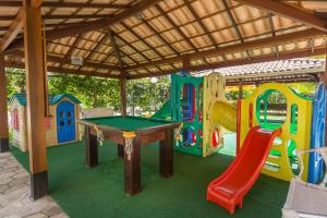 a play area with a pool table and a slide at Porto Geraes Praia Hotel in Porto Seguro