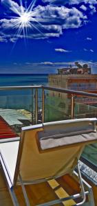 a bench on a balcony with a view of the ocean at Pioneer Excelsior Rooms in Paralia Katerinis