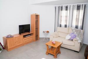 a living room with a couch and a tv at Apartamento playas calpe in Calpe