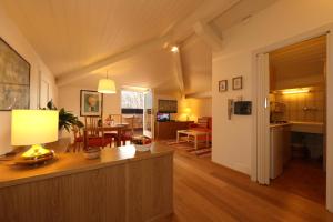 a living room with a kitchen and a dining room at La Spiaggia in Oliveto Lario