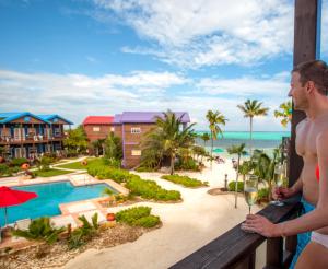 a man and woman standing on a balcony looking at the ocean at X'tan Ha- The Waterfront in San Pedro