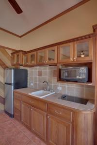 a kitchen with a sink and a refrigerator at X'tan Ha- The Waterfront in San Pedro