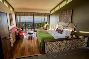 a hotel room with a bed and a balcony at Chayote Lodge in Zarcero