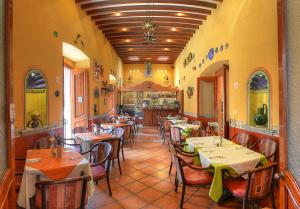 a dining room with tables and chairs in a restaurant at Hotel Boutique Parador San Miguel Oaxaca in Oaxaca City