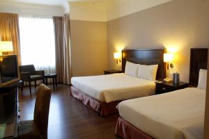 Postel nebo postele na pokoji v ubytování Grand Kampar Hotel
