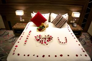 a large bed with valentines hearts on it at Sumou Al Khobar Hotel in Al Khobar