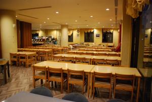 a restaurant with rows of tables and chairs at Osaka International Youth Hostel in Takaishi