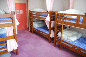 a room with four bunk beds in a hostel at Osaka International Youth Hostel in Takaishi
