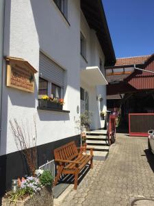 a wooden bench sitting outside of a building at Haus Gisela in Endingen