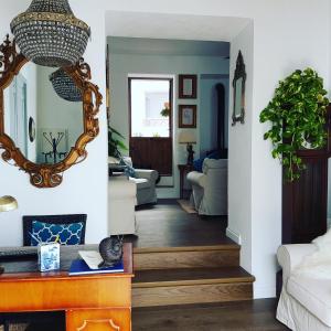 a hallway with a mirror and a living room at Casa Rural Miller's of Frigiliana in Frigiliana