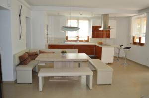a kitchen and living room with a table and chairs at Villa - ZMRD in Zamárdi