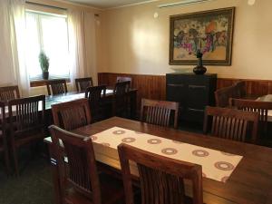 a dining room with wooden tables and chairs at Chata Rosa in Malenovice