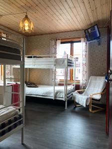 a room with two bunk beds and a tv at Prinsgården B&B rum stugor in Mora