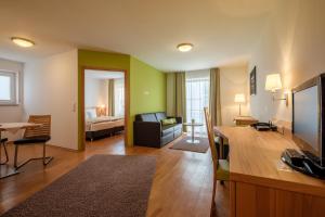 a living room with a couch and a table in a room at BusinessHotel Schramberg in Schramberg