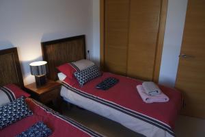 スシナにあるHacienda Requelme Golf Resort Apartmentの小さなベッドルーム(ベッド2台、ランプ付)