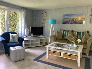 a living room with a couch and a coffee table at Pension Inselparadies Zingst in Zingst