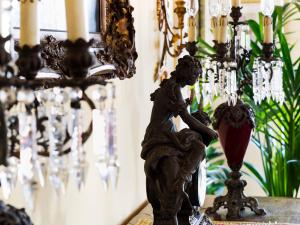 a statue of a cherub on a table next to a chandelier at Hotel Sirius in Taormina