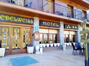 a store front of a hotel with chairs and tables at Edelweiss Hotel in Torla-Ordesa