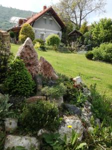 a rock garden in front of a house at Margó Nyaraló in Balatonederics