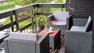 a patio with two chairs and a table on a balcony at Aparthouse Ani in Radovljica