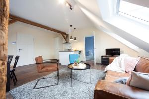a living room with a couch and a table at Apartments LUDGERUSHOF in Bocholt