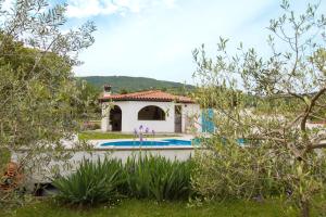 a house with a swimming pool in a garden at Apartment Kampel in Koper