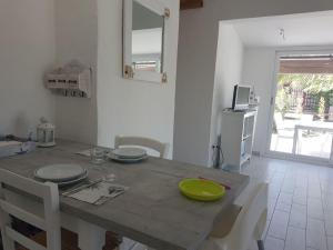 a dining room table with a green plate on it at Ca' Viscomi in San Teodoro +20 photos
