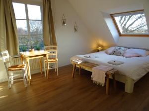 1 dormitorio con cama, mesa y escritorio en Bed and Breakfast Maas en Waal en Winssen