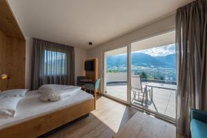 Postel nebo postele na pokoji v ubytování Hotel Garni Herz