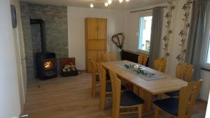 a dining room with a table and a wood stove at Ferienwohnung Kylltal in Birresborn