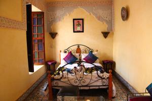 a bedroom with a bed in a room at Riad Bibtia in Marrakech +154 photos