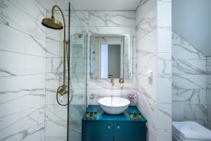 a bathroom with a sink and a glass shower at Veneziano Boutique Hotel in Heraklio
