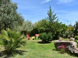 a garden with a play house and trees and grass at Villa Tanit in Lotzorai