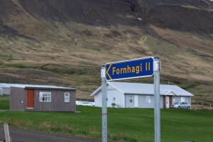 a blue street sign on the side of a road at Fornhagi 2 in Akureyri