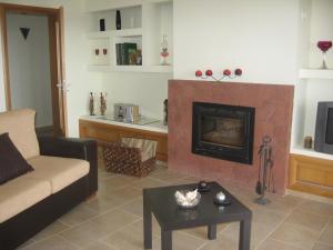 a living room with a couch and a fireplace at Villa Casa do Monte in Silves