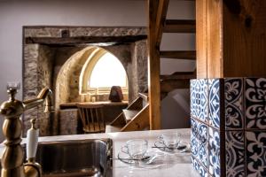 a kitchen with a sink and glasses on a counter at Veneziano Boutique Hotel in Heraklio +31 photos