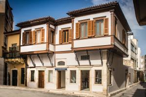 a building with wooden windows on a street at Veneziano Boutique Hotel in Heraklio