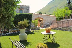 un jardín con una mesa y un jarrón en el césped en Casale Maddalena en Carini