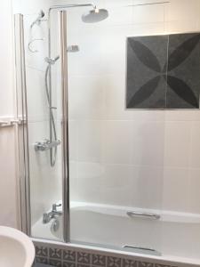 a shower with a glass door in a bathroom at Pearl Cottage in Blockley +34 photos