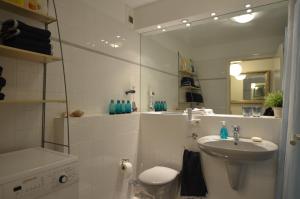 a bathroom with a sink and a toilet and a mirror at All-in-One in Berlin +32 photos