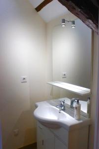 a bathroom with a sink and a mirror at Le Studio in Montignac +5 photos