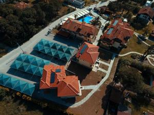 an overhead view of a house with a swimming pool at Vergos Hotel in Vourvourou