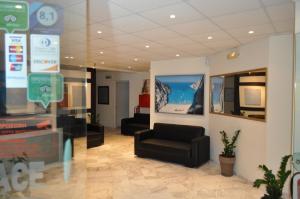 a lobby with a chair and a couch in a building at Garden Palace Hotel in Laganas +144 photos