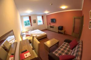 a view of a hotel room with a bedroom at Wellness Hotel Hukvaldy POLOPENZE A WELLNESS V CENĚ in Příbor